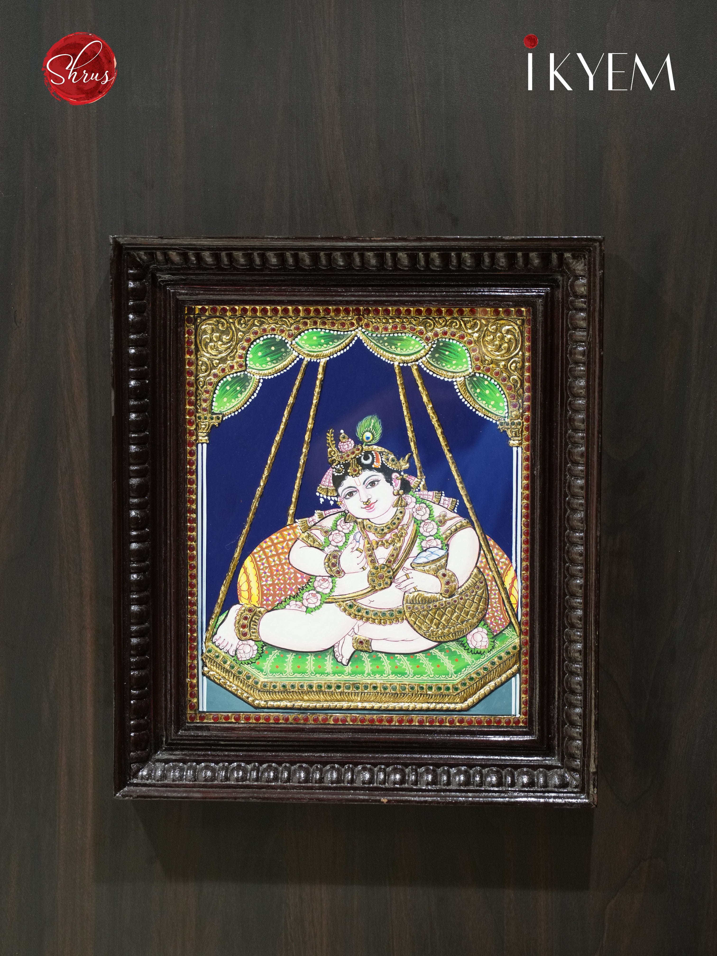 Krishna on Unjal - Tanjore Painting embelished with Pure Gold Foil, Stones and Mani Frame